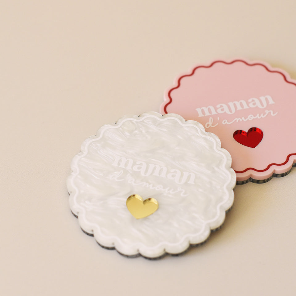 Miroir de poche forme rond festonné avec impression contour, inscription « maman d’amour » et coeur en plexi miroir incrusté au centre. Un coloris rose et rouge (fond plexi rose, contour rouge, texte blanc, coeur en plexi miroir rouge)
Un coloris marbré blanc (fond plexi marbré blanc, contour et teste blanc, coeur en plexi miroir or)